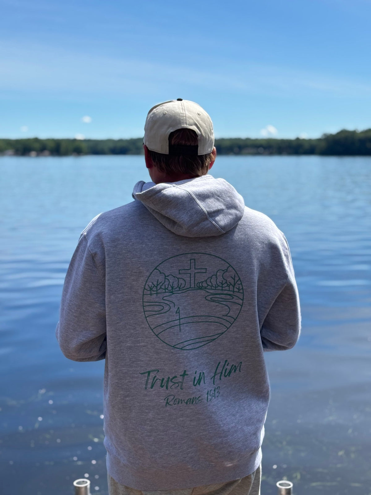 a man standing in front of a body of water